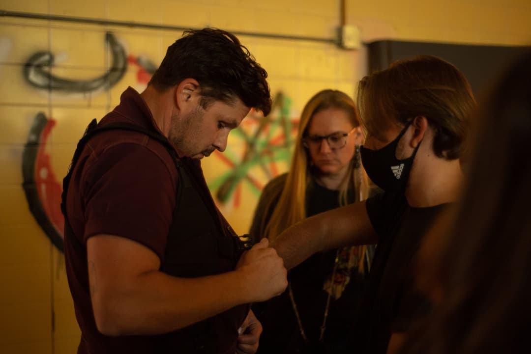 Behind the scenes photo 26 from Clone Cops production showing sound mixer hunter vickers, costume designer hannah schmidt, and ted welch prepare for a scene